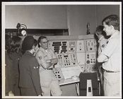 Photograph of Air Force ROTC Cadets and officer standing in front of equipment